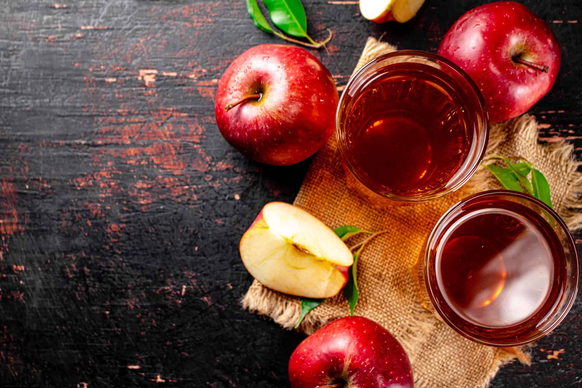 Fresh apple juice. Against a dark background.