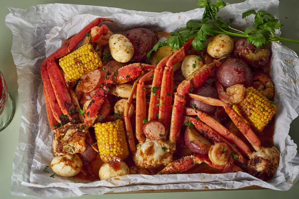 finished oven baked seafood boil with crab, shrimp, corn, potatoes, eggs and sausage.