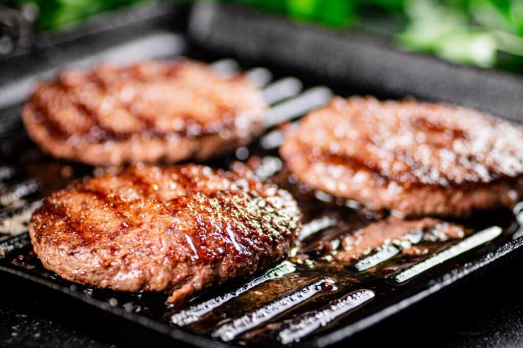 Grilled burger in a frying pan.