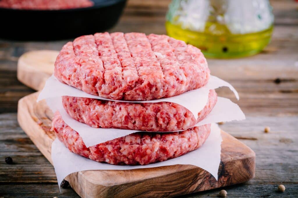 Ingredients for burgers: raw minced beef cutlets