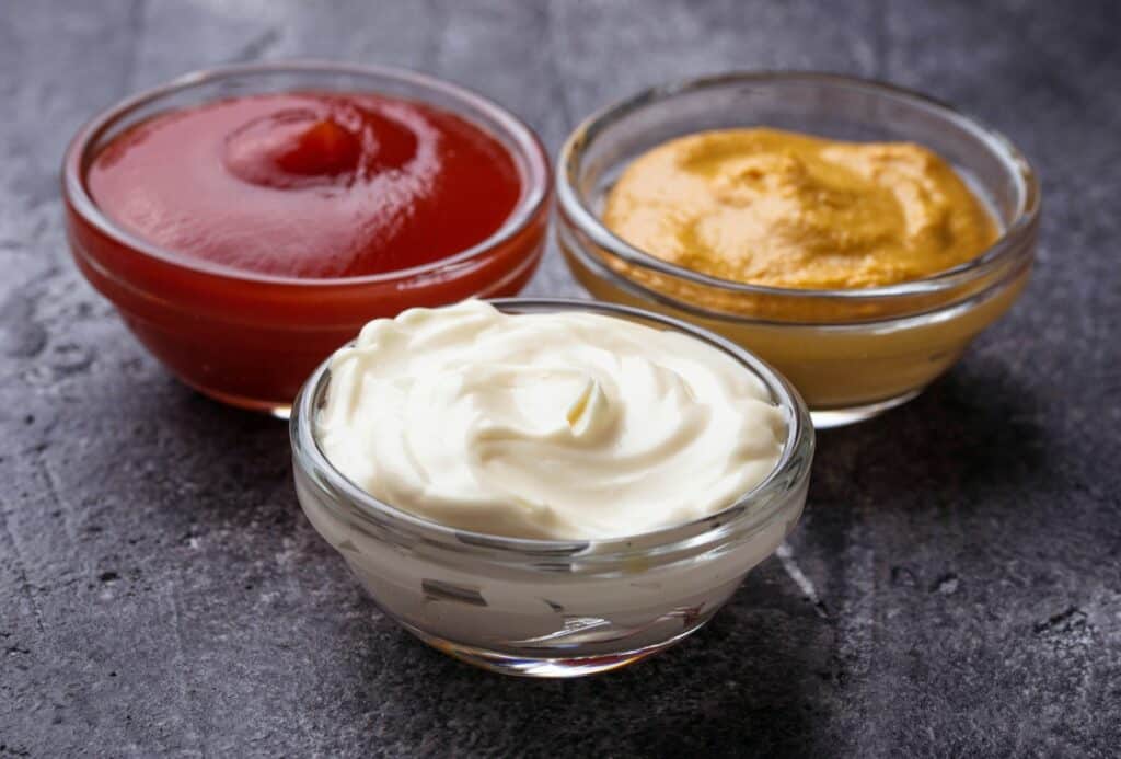 Set of different sauces: mustard, ketchup, mayonnaise.