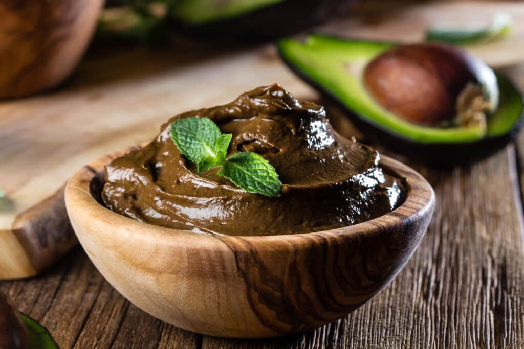 Avocado chocolate mousse in olive wooden bowl