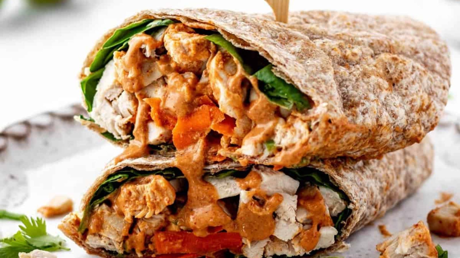 Got Dinner Dilemmas? These 22 Guilt Free Dishes Have the Answers Spicy Thai Chicken Wraps Recipe with Peanut Sauce by Haute and Healthy Living