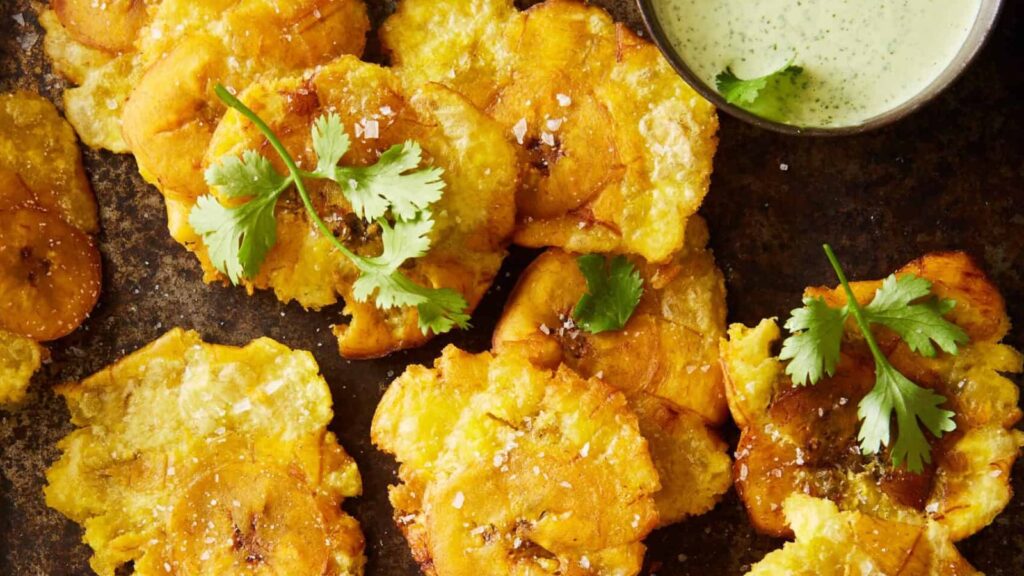 22 Caribbean Dishes That'll Knock Your Flip Flops Off How to Make Tostones with Cilantro-Jalapeño Green Sauce by Little Black Skillet